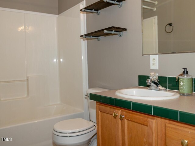 full bathroom featuring tub / shower combination, toilet, and vanity