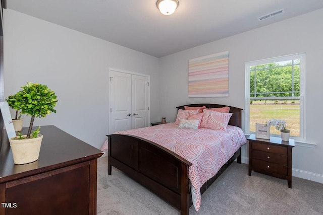 carpeted bedroom featuring a closet