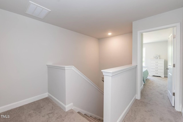 corridor with recessed lighting, carpet flooring, visible vents, an upstairs landing, and baseboards