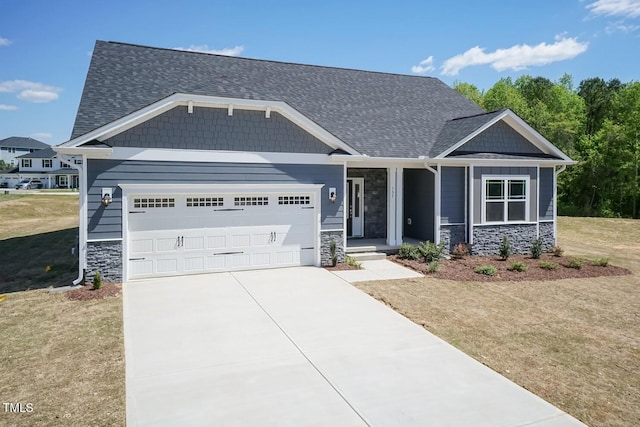 157 Newport Lndg Lot 95, Garner, NC 27529 - craftsman house featuring stone siding, a garage, driveway, covered porch, and a shingled roof