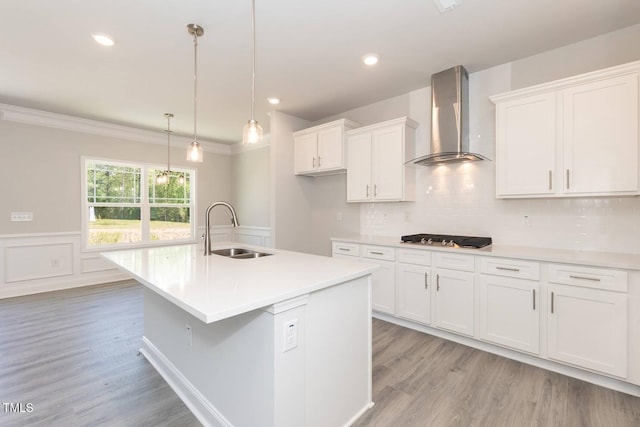 157 Newport Lndg Lot 95, Garner, NC 27529 - kitchen with wall chimney range hood, a sink, light wood-style floors, white cabinets, and stainless steel gas cooktop