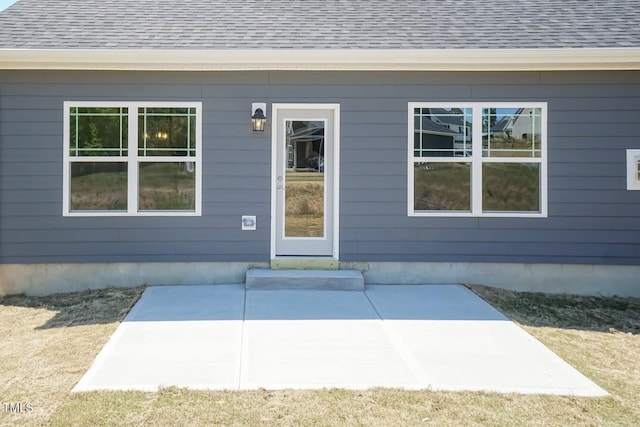 157 Newport Lndg Lot 95, Garner, NC 27529 - view of exterior entry featuring a patio and a shingled roof
