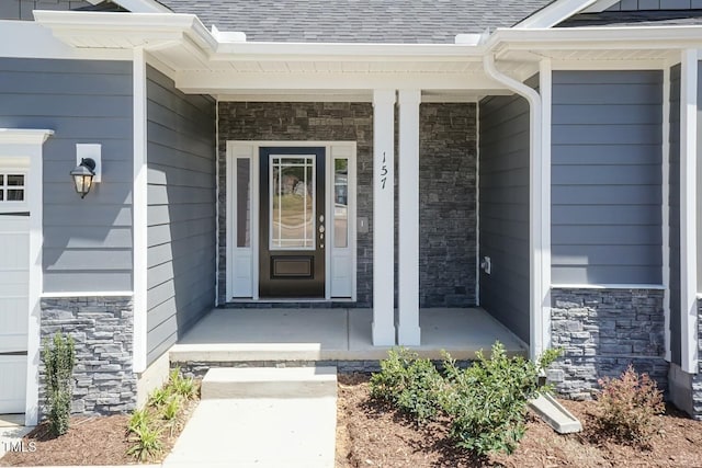 157 Newport Lndg Lot 95, Garner, NC 27529 - property entrance with stone siding, covered porch, and a shingled roof
