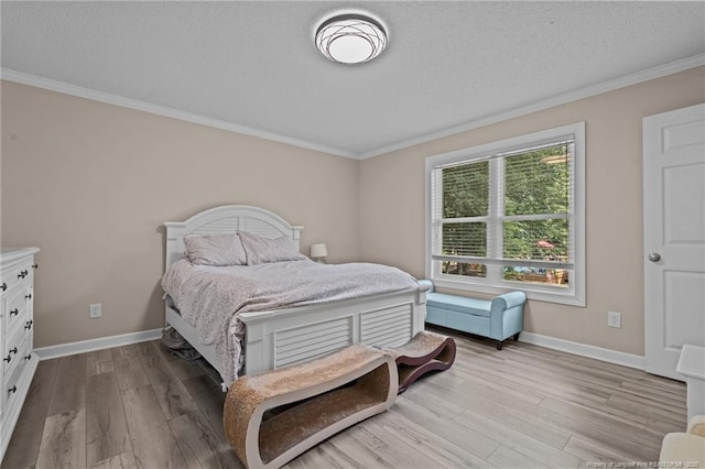 bedroom featuring light hardwood / wood-style floors, a textured ceiling, and crown molding