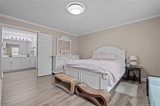 bedroom featuring ensuite bath, light wood-type flooring, and crown molding