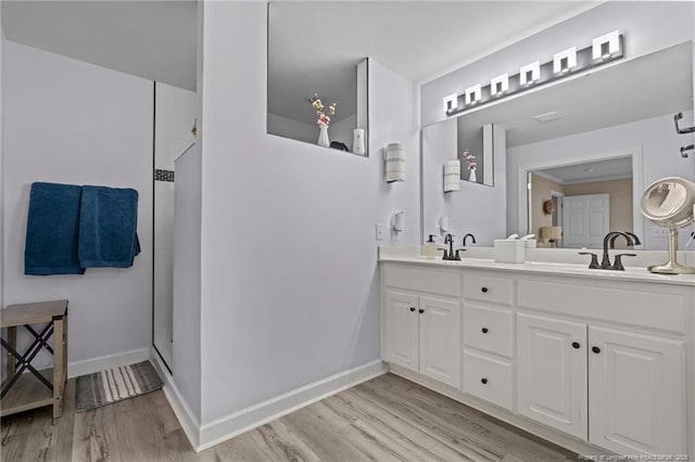 bathroom with a shower, hardwood / wood-style flooring, and vanity