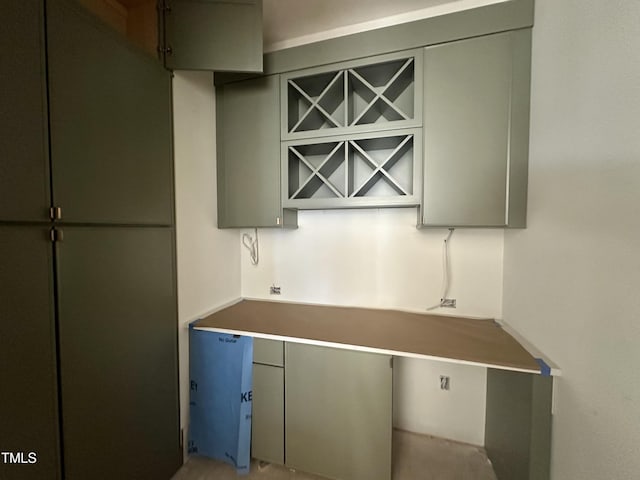 kitchen with freestanding refrigerator and gray cabinetry