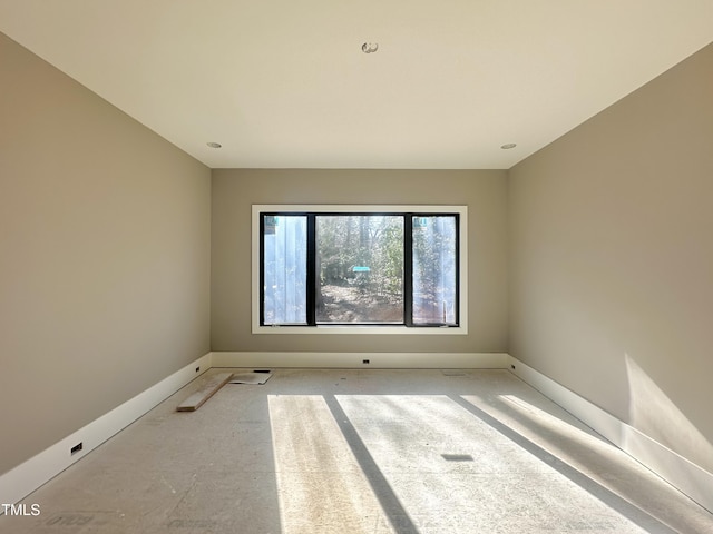 unfurnished room featuring baseboards