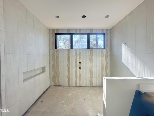 unfurnished room with tile walls