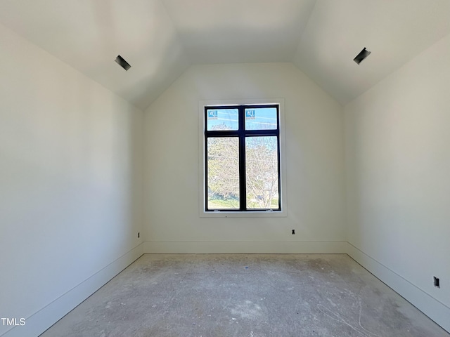 additional living space with lofted ceiling and baseboards