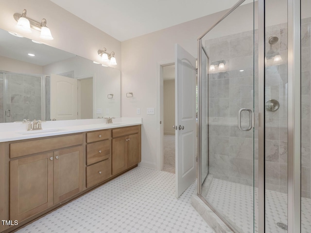 full bath with a stall shower, double vanity, and a sink