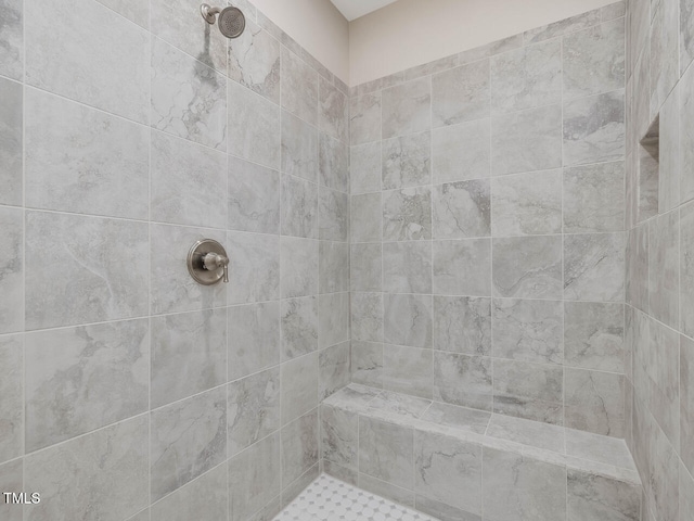 bathroom with tiled shower