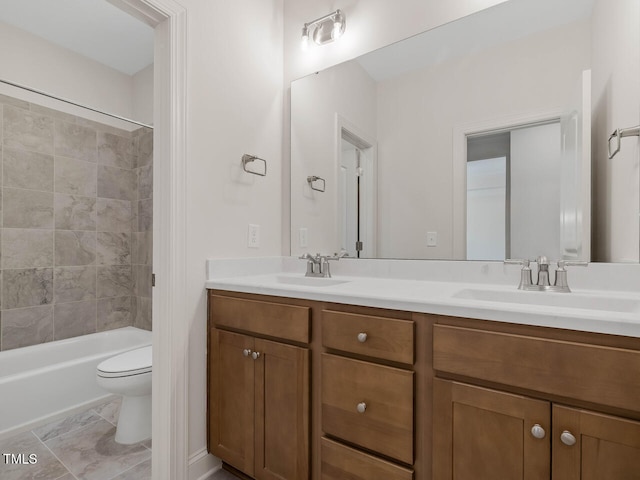 full bathroom with vanity, tiled shower / bath combo, toilet, and tile patterned floors