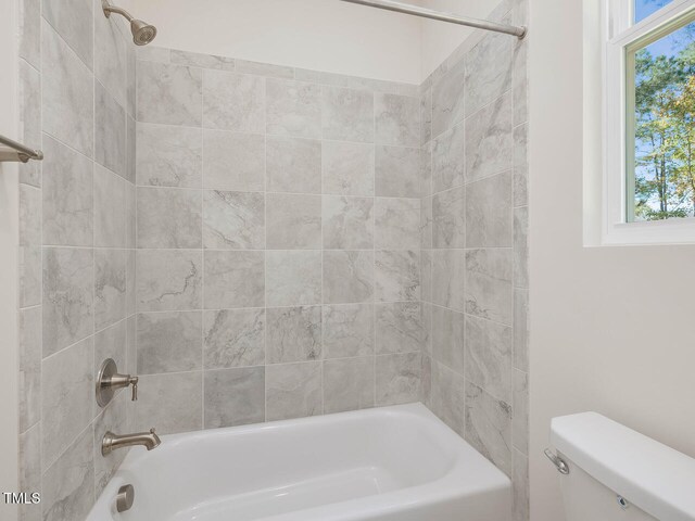 full bathroom with toilet, a wealth of natural light, and bathtub / shower combination