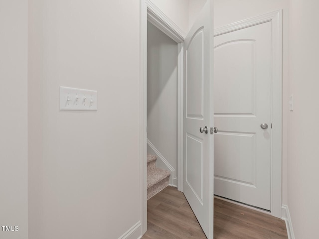 interior space featuring stairway, baseboards, and wood finished floors