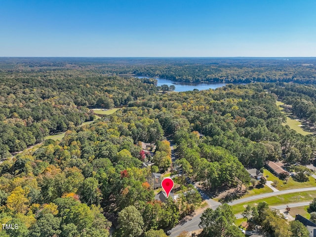 drone / aerial view featuring a water view and a forest view