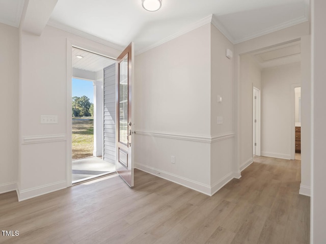 entrance foyer with baseboards, ornamental molding, and wood finished floors