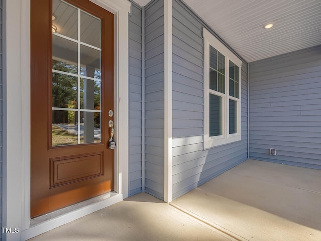 view of exterior entry with covered porch