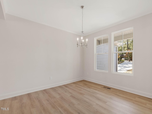 unfurnished room with ornamental molding, a chandelier, and light wood-type flooring