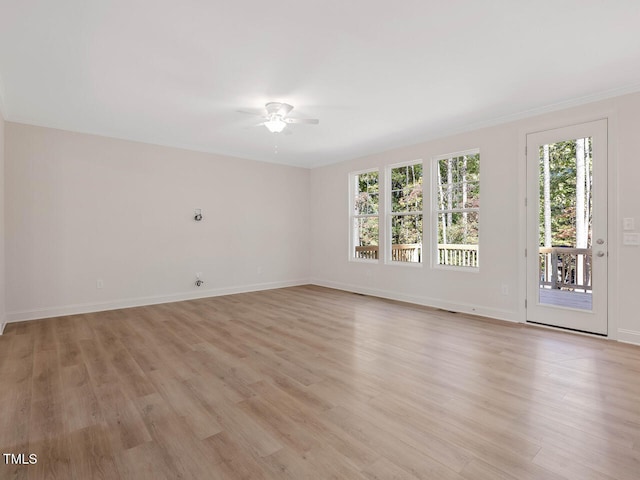 unfurnished room with light hardwood / wood-style flooring, ceiling fan, crown molding, and a wealth of natural light