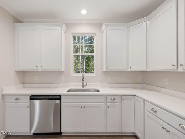 kitchen with white cabinetry, dishwasher, sink, and ornamental molding