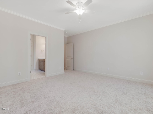 carpeted spare room featuring crown molding and ceiling fan