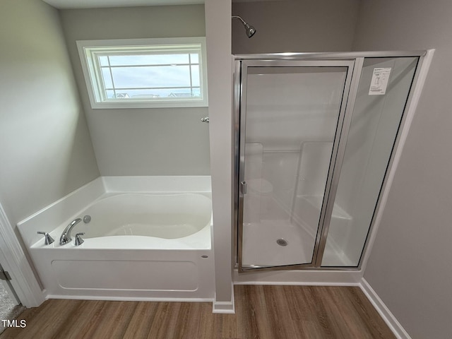 bathroom with plus walk in shower and hardwood / wood-style floors