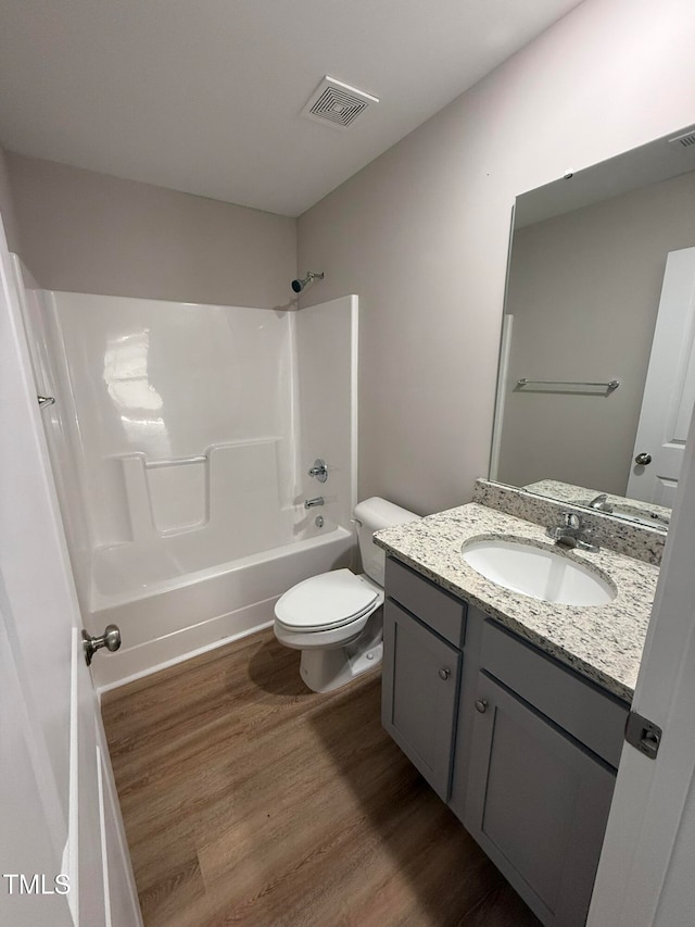 full bathroom featuring tub / shower combination, vanity, toilet, and wood-type flooring