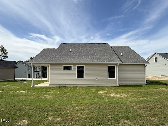 rear view of property with a patio and a yard