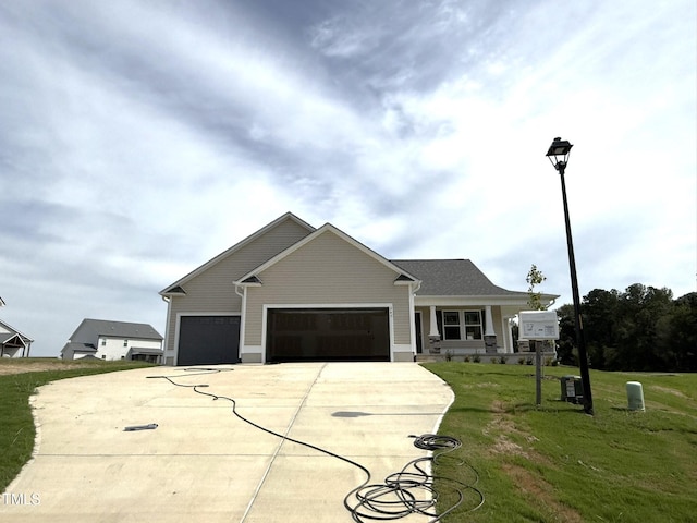 view of front of home with a garage and a front lawn