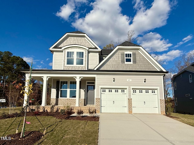 craftsman-style home with a porch, a garage, and a front lawn