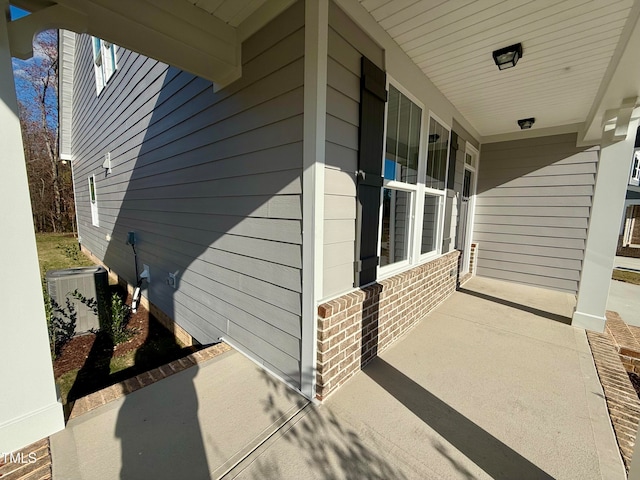 view of side of property with covered porch