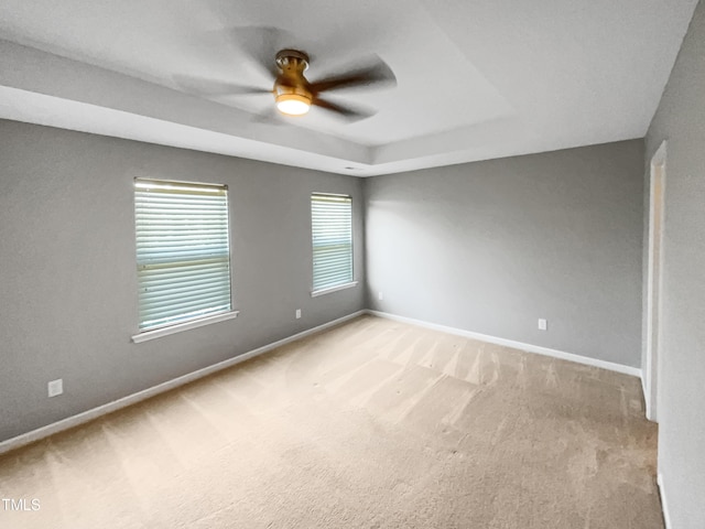 unfurnished room featuring light colored carpet and ceiling fan