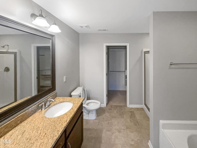 bathroom featuring vanity, toilet, and walk in shower