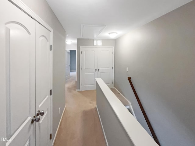 hallway featuring light colored carpet