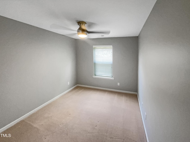 empty room featuring light colored carpet and ceiling fan