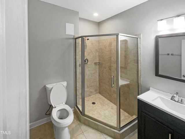 bathroom featuring walk in shower, vanity, toilet, and tile patterned flooring