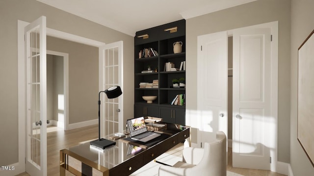 home office featuring built in shelves, light hardwood / wood-style floors, and french doors