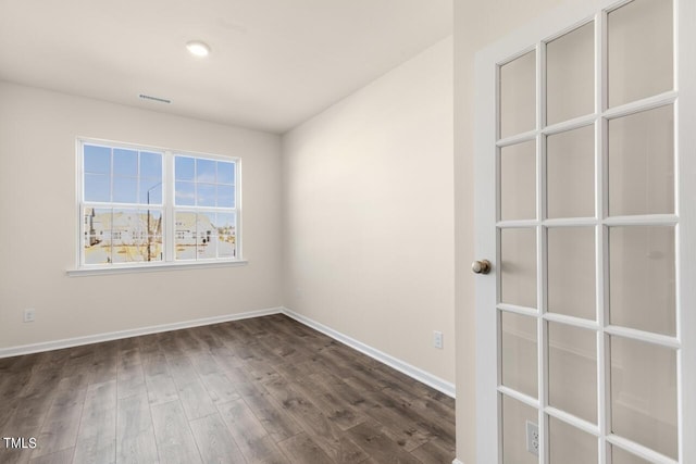 unfurnished room with dark hardwood / wood-style flooring