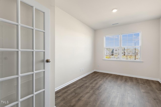 empty room with dark hardwood / wood-style floors