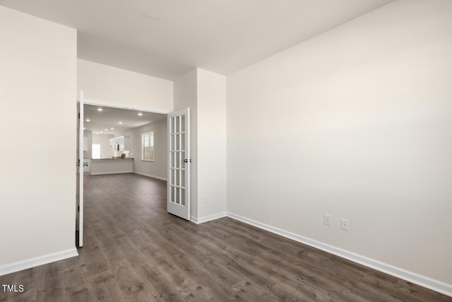 spare room with french doors and dark hardwood / wood-style floors