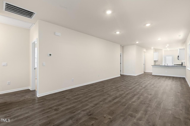 unfurnished living room featuring dark hardwood / wood-style flooring