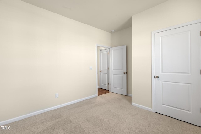 unfurnished bedroom featuring light carpet