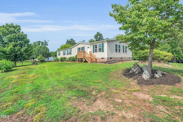 exterior space featuring a wooden deck and a front yard