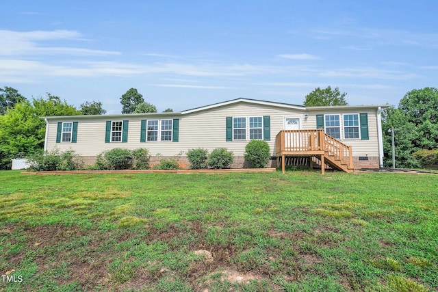 manufactured / mobile home with a deck and a front lawn