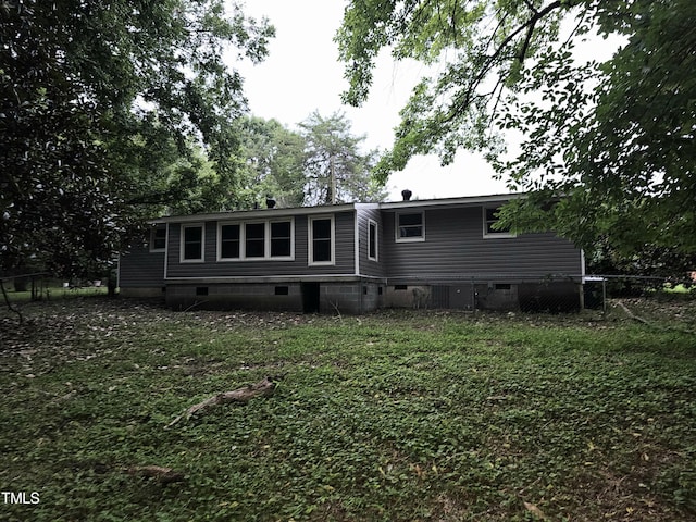 back of property featuring a yard