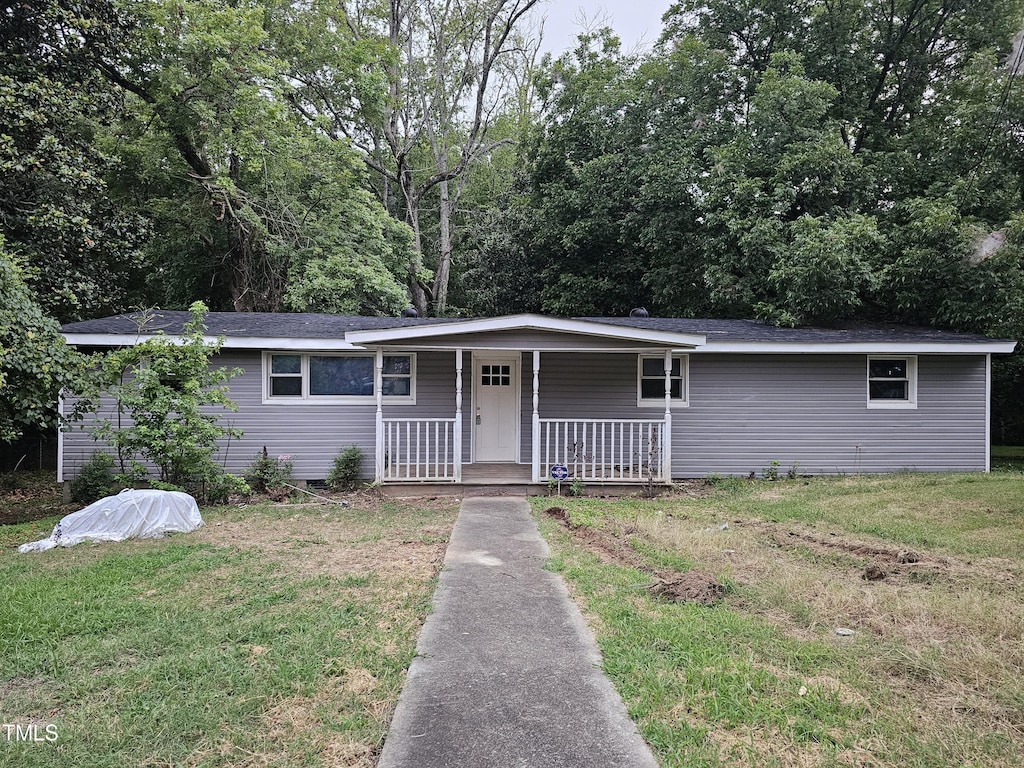 ranch-style home featuring a front yard and a porch