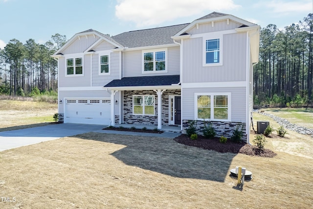 craftsman inspired home featuring concrete driveway, stone siding, roof with shingles, and an attached garage