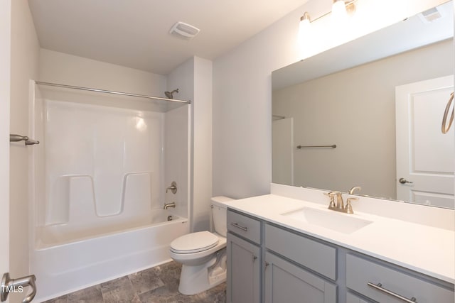 full bathroom featuring washtub / shower combination, vanity, and toilet