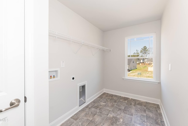 laundry area featuring laundry area, baseboards, stone finish floor, hookup for a washing machine, and electric dryer hookup